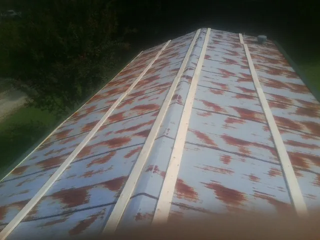 Rusted metal roof panels with new wood purlins before replacement — Storm Damage Roof Repair in River Ranch by Roofing Brothers